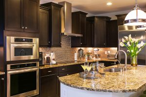 Kitchen featuring tile back splash and granite counters